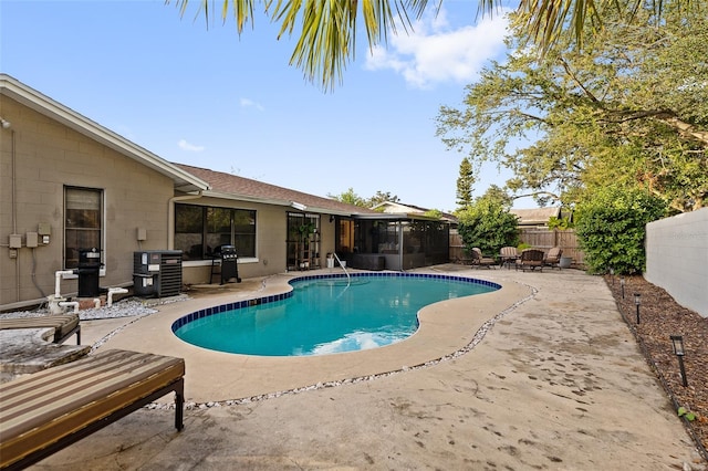 view of pool with grilling area and a patio