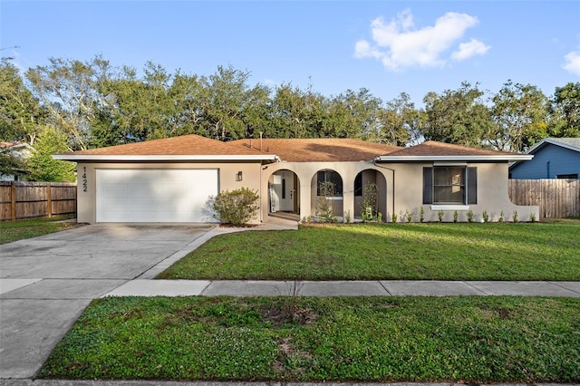 view of front of home with a front yard and a garage