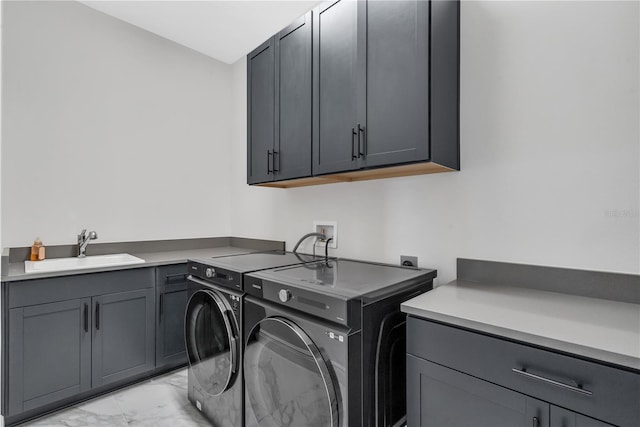 washroom featuring cabinets, independent washer and dryer, and sink