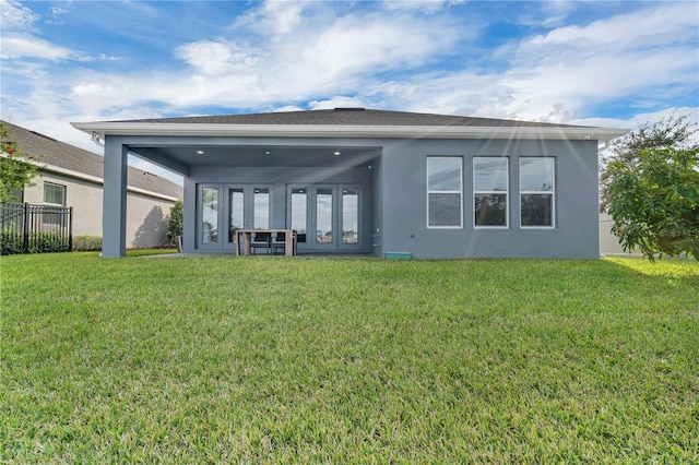 back of house featuring a yard