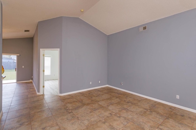 spare room featuring high vaulted ceiling