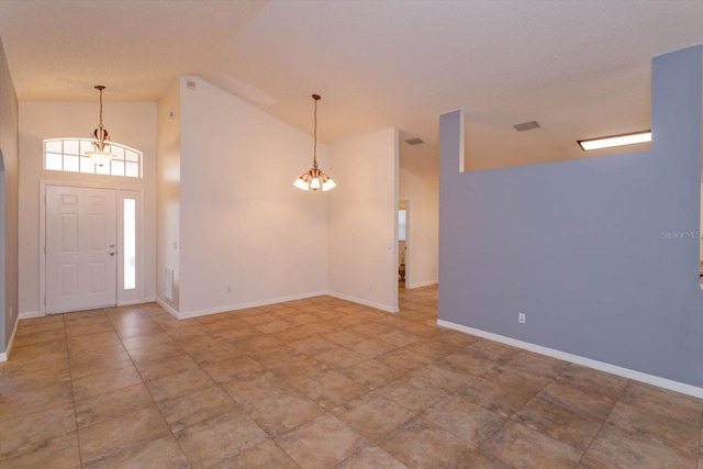 entrance foyer featuring high vaulted ceiling and a chandelier