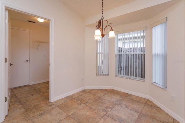 unfurnished dining area with an inviting chandelier