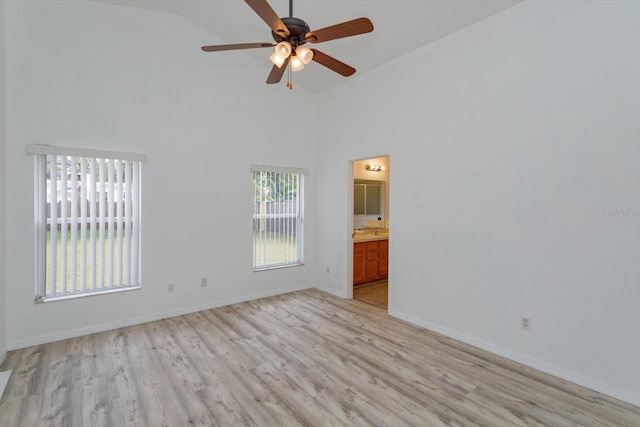 unfurnished room featuring ceiling fan, light hardwood / wood-style floors, and high vaulted ceiling