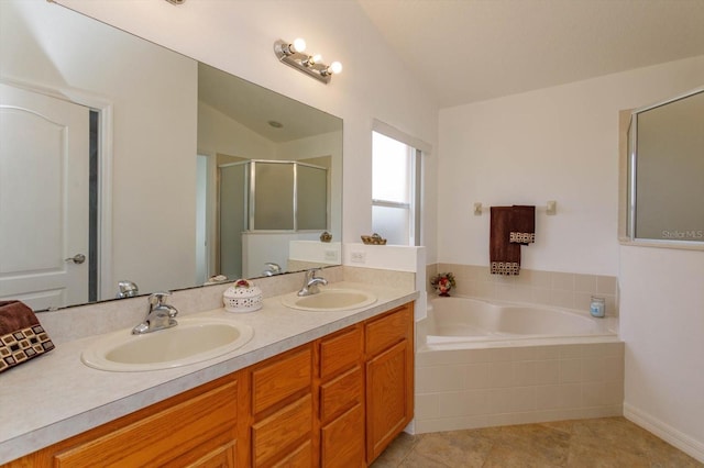 bathroom with tile patterned floors, vanity, independent shower and bath, and vaulted ceiling