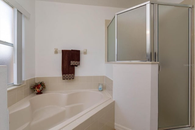 bathroom featuring shower with separate bathtub