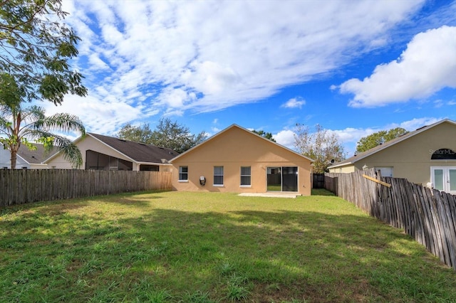 back of property featuring a lawn