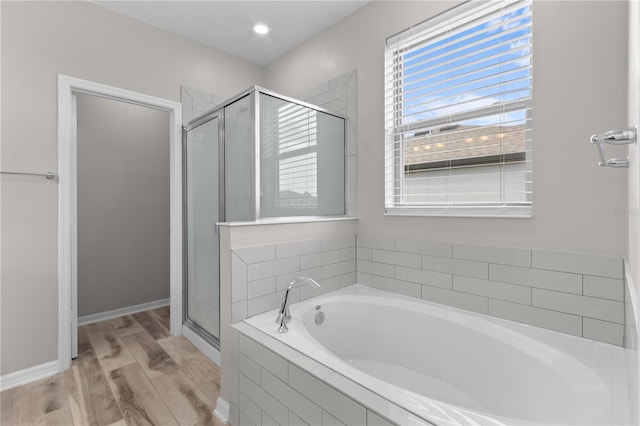 bathroom featuring separate shower and tub and hardwood / wood-style floors