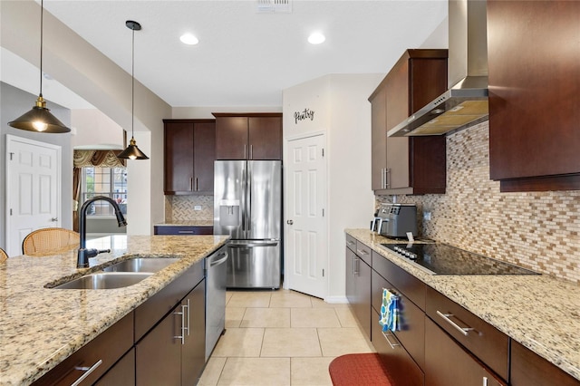 kitchen featuring wall chimney range hood, sink, light stone countertops, tasteful backsplash, and stainless steel appliances