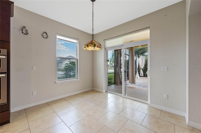 unfurnished dining area featuring light tile patterned floors