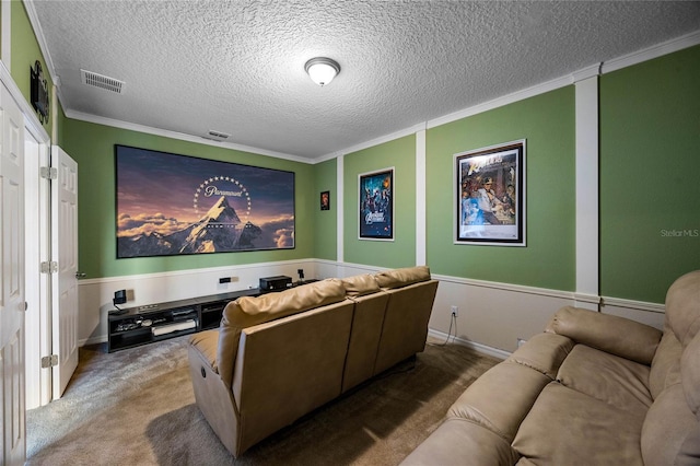 carpeted home theater room featuring crown molding and a textured ceiling