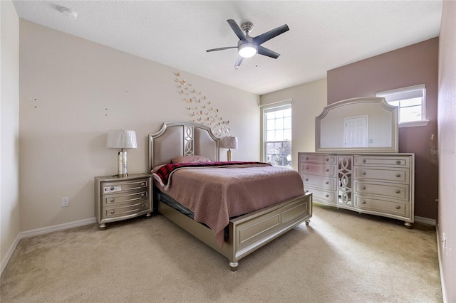 carpeted bedroom with ceiling fan, a textured ceiling, and multiple windows