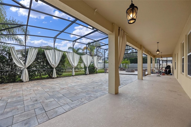 view of patio featuring glass enclosure