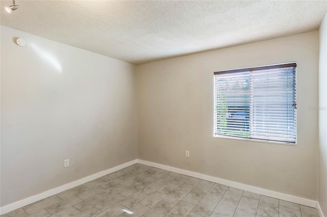 spare room with a textured ceiling