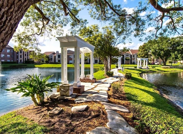 view of home's community with a yard and a water view