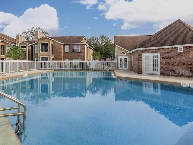 view of pool with french doors