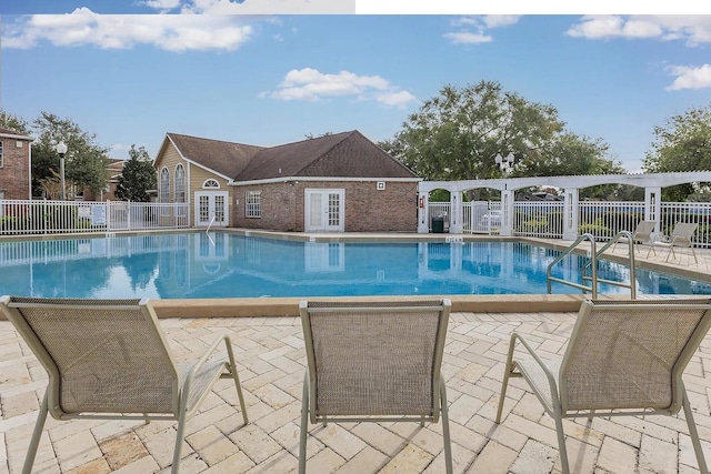 view of pool featuring a patio area and french doors