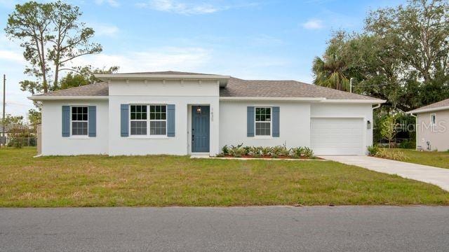 view of front of house with a garage and a front yard