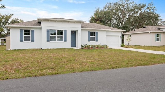 view of front of property with a front yard and a garage