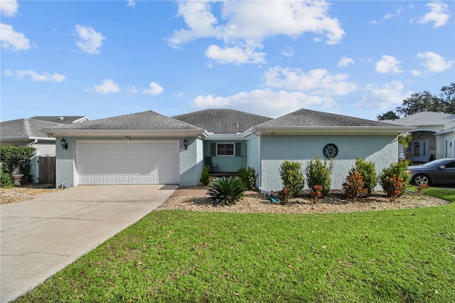 single story home with a garage and a front lawn