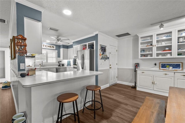 kitchen featuring white cabinetry, ceiling fan, dark wood-type flooring, a textured ceiling, and appliances with stainless steel finishes