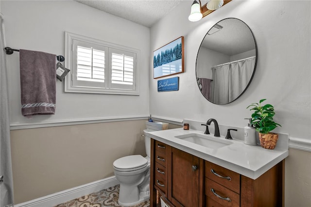 bathroom with vanity, a textured ceiling, and toilet