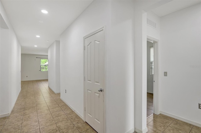 hall with light tile patterned floors