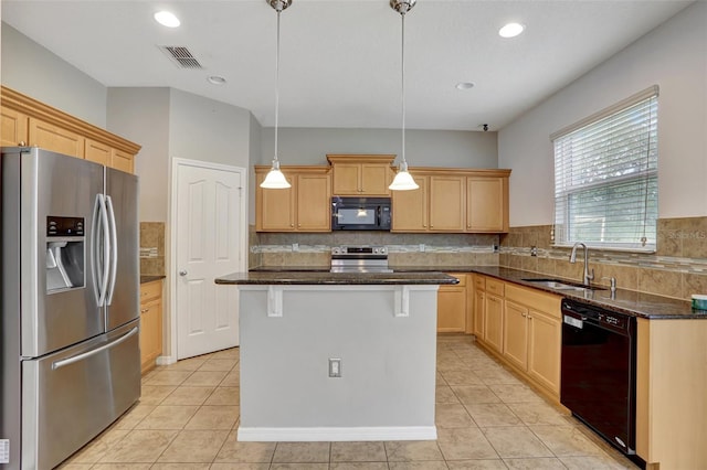 kitchen featuring a center island, black appliances, sink, hanging light fixtures, and dark stone countertops