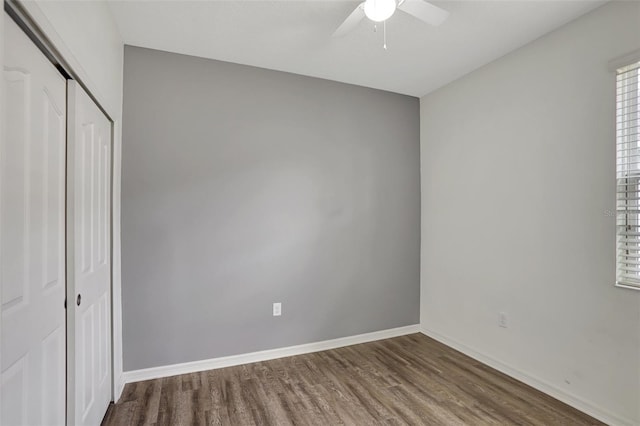 unfurnished bedroom with ceiling fan, a closet, and hardwood / wood-style flooring