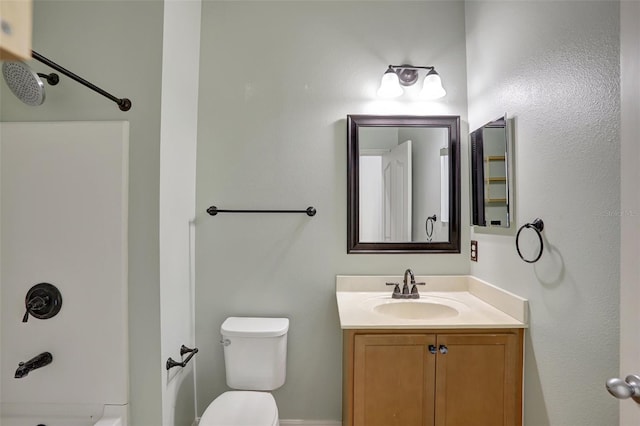 bathroom featuring vanity, toilet, and walk in shower