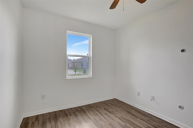 spare room with hardwood / wood-style flooring and ceiling fan