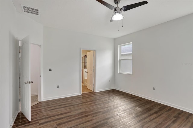 unfurnished bedroom with connected bathroom, ceiling fan, and dark hardwood / wood-style floors