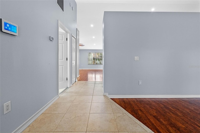 hall with light tile patterned floors