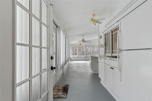 interior space with ceiling fan and lofted ceiling