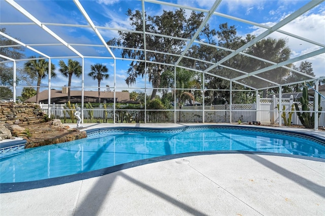 view of swimming pool with a patio and glass enclosure