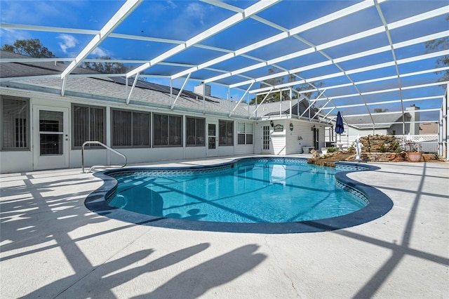 view of pool featuring glass enclosure and a patio