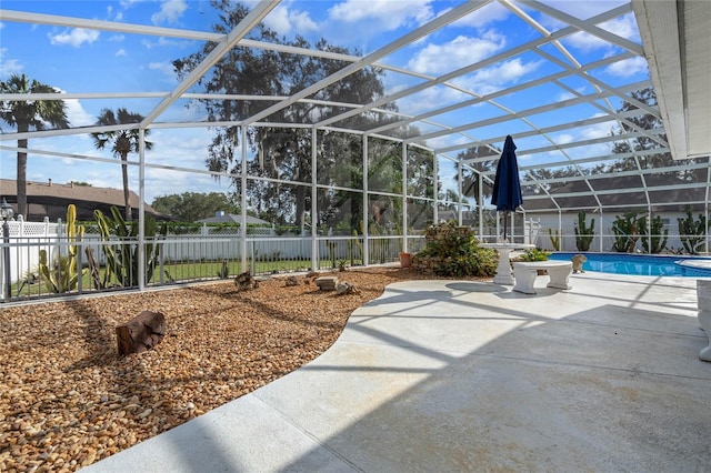 view of patio / terrace with glass enclosure and a fenced in pool