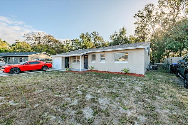 single story home with a front lawn and a garage