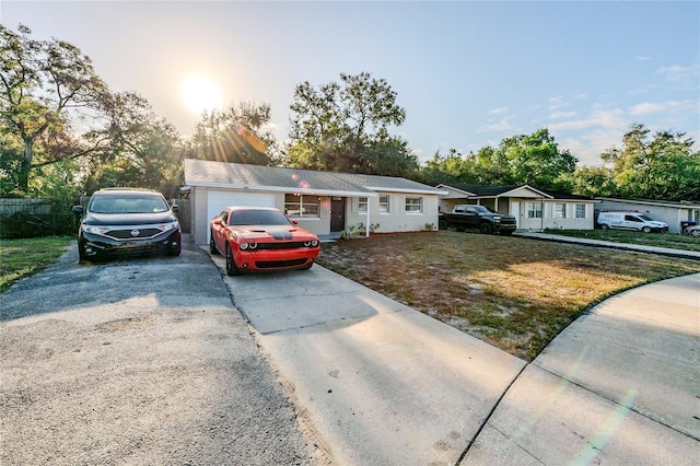 view of front of property featuring a lawn and a garage