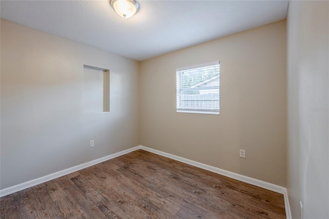 empty room with hardwood / wood-style flooring