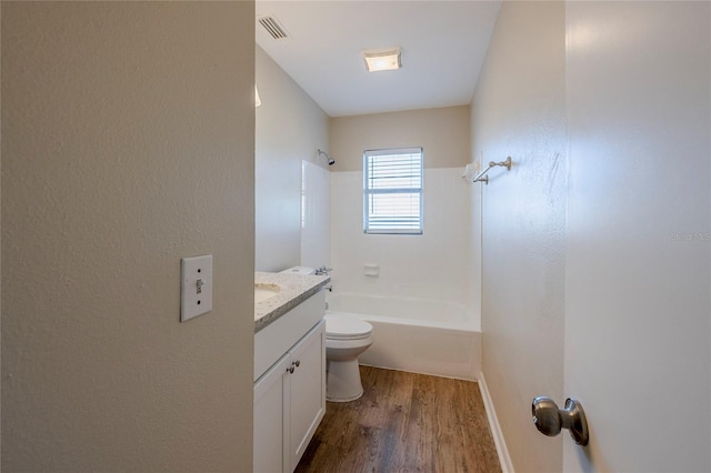 full bathroom featuring toilet, wood-type flooring, vanity, and shower / bath combination