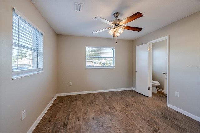 unfurnished bedroom with ceiling fan, connected bathroom, and dark hardwood / wood-style floors