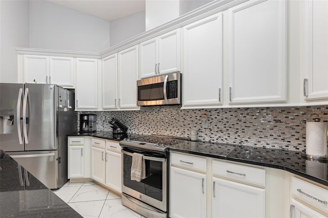 kitchen featuring tasteful backsplash, white cabinetry, and stainless steel appliances