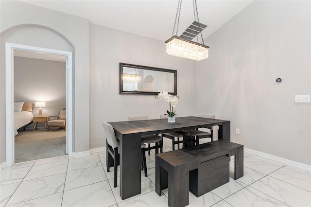 dining room featuring vaulted ceiling