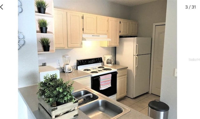 kitchen with decorative backsplash, light tile patterned flooring, and white appliances