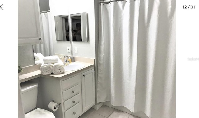 bathroom featuring toilet, vanity, and tile patterned floors