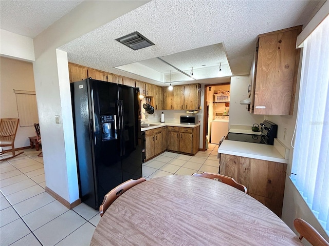 kitchen with light tile patterned flooring, sink, range, a textured ceiling, and black refrigerator with ice dispenser