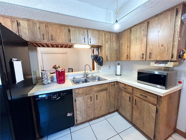 kitchen featuring sink, black appliances, a textured ceiling, and light tile patterned flooring