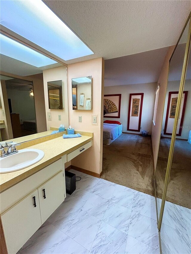 bathroom featuring vanity and a textured ceiling