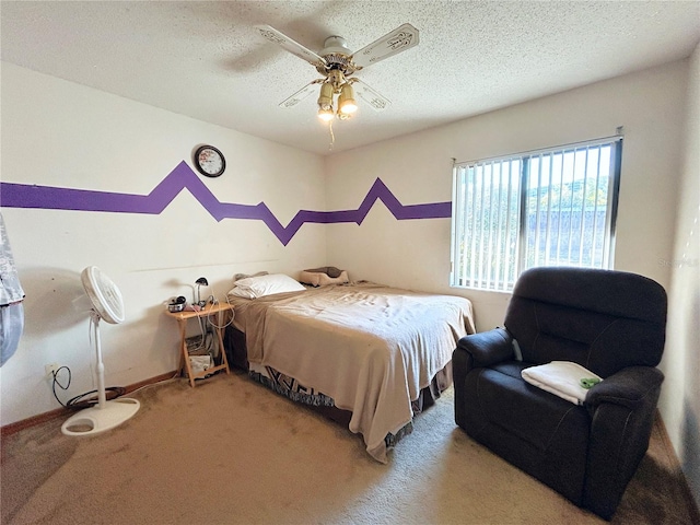 carpeted bedroom featuring ceiling fan and a textured ceiling